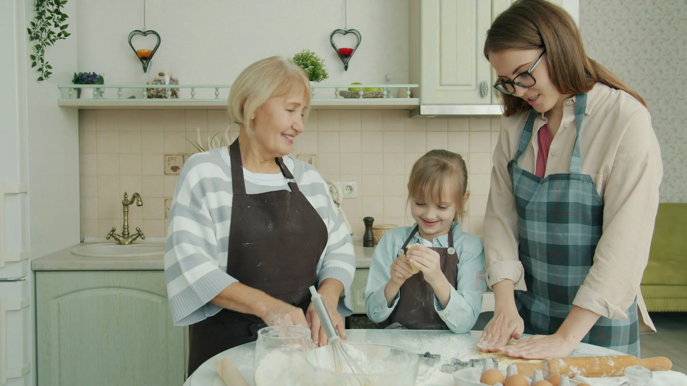 Tres generaciones de una familia cocinando juntas en casa